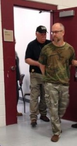 OCSO Investigator Keith Matz escorts James Flanders following Flanders arrest at his rural home outside Cochise Arizona.